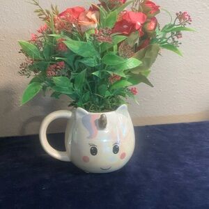 Cute little unicorn cup with artificial flowers